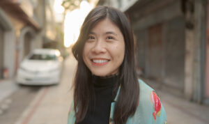 Headshot of Li-Ting Chang with street backgroun