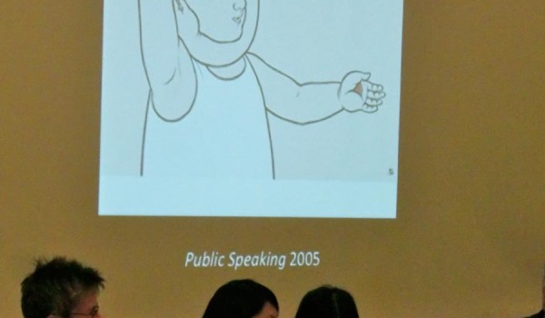 4 speakers in front of a projector screen displaying "Public Speaking 2005"